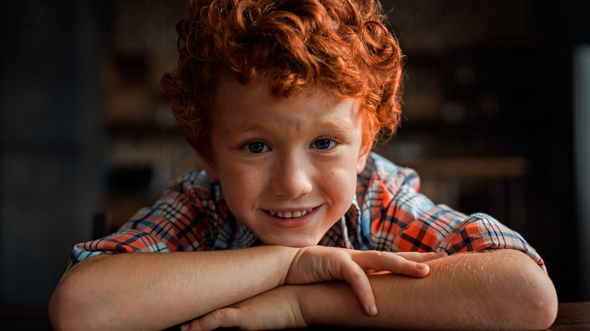 Boy with red hair smiling